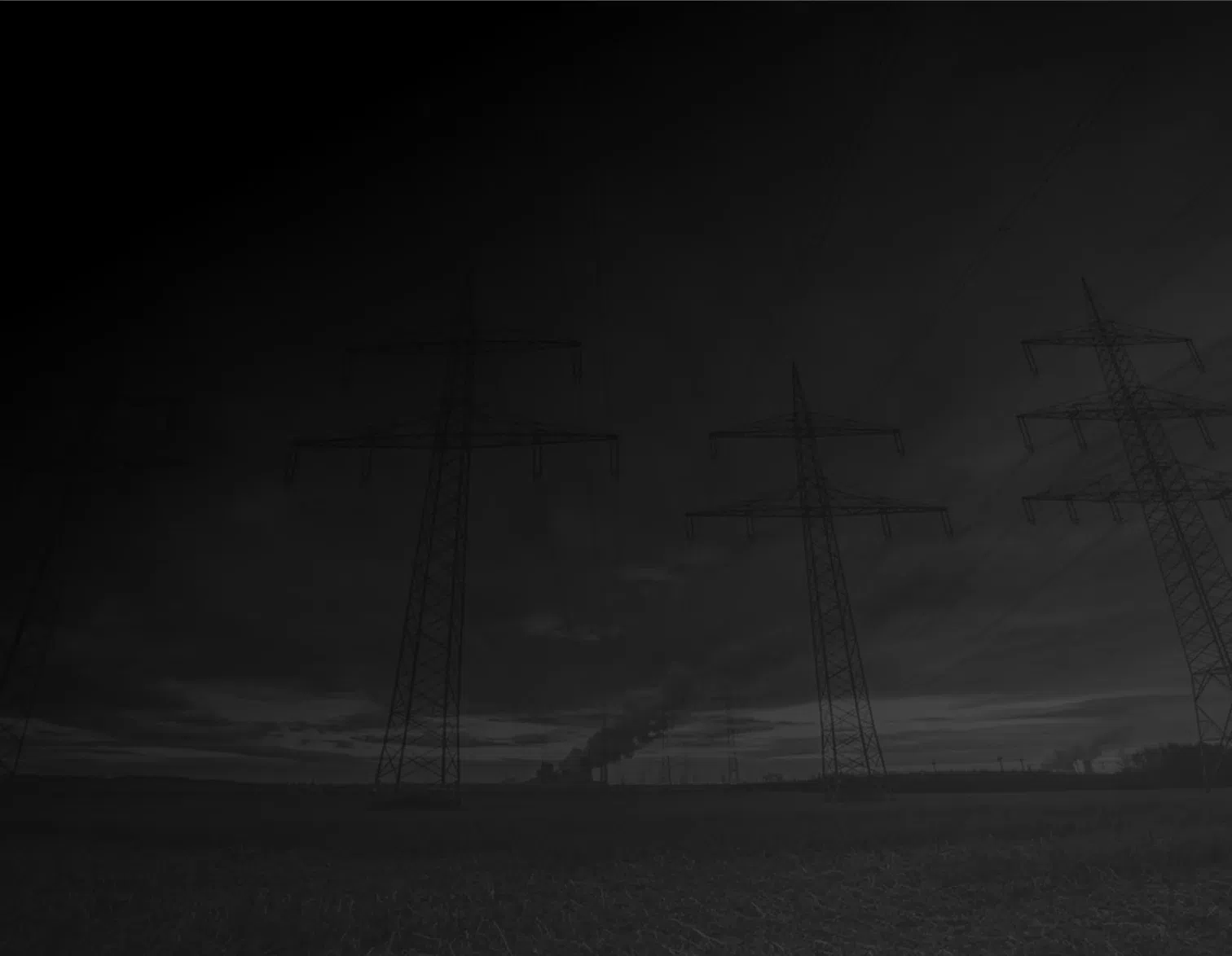 Ground view looking up at tall electrical line towers